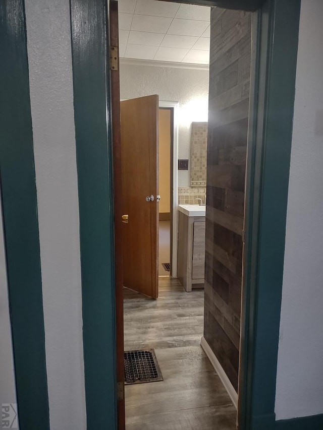 hallway featuring visible vents and light wood-style flooring