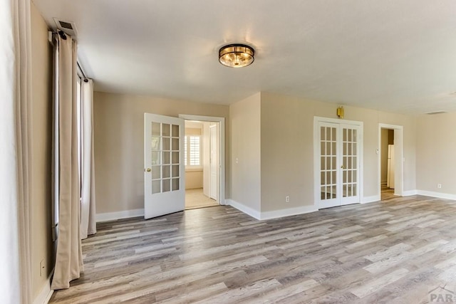 319 S Main St, La Veta, CO 81055 - spare room featuring light wood-style floors, french doors, and baseboards