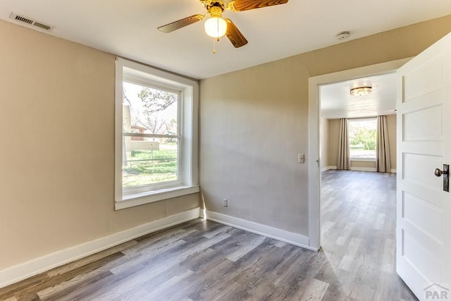 319 S Main St, La Veta, CO 81055 - empty room featuring wood finished floors, a smoke detector, a ceiling fan, and baseboards