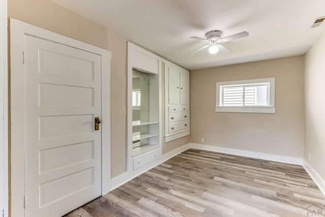 319 S Main St, La Veta, CO 81055 - unfurnished bedroom featuring baseboards, light wood-style flooring, and a ceiling fan