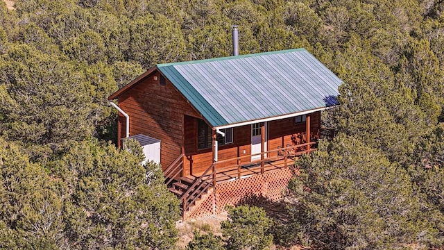 exterior space featuring a forest view