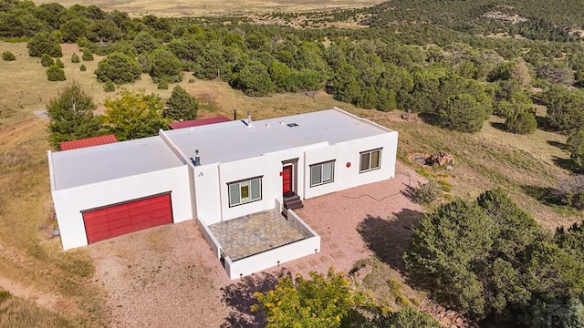 birds eye view of property with a wooded view