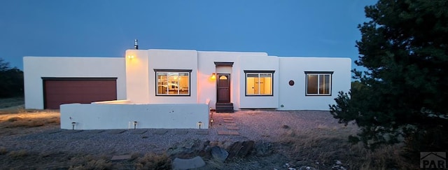 view of front facade with an attached garage and stucco siding