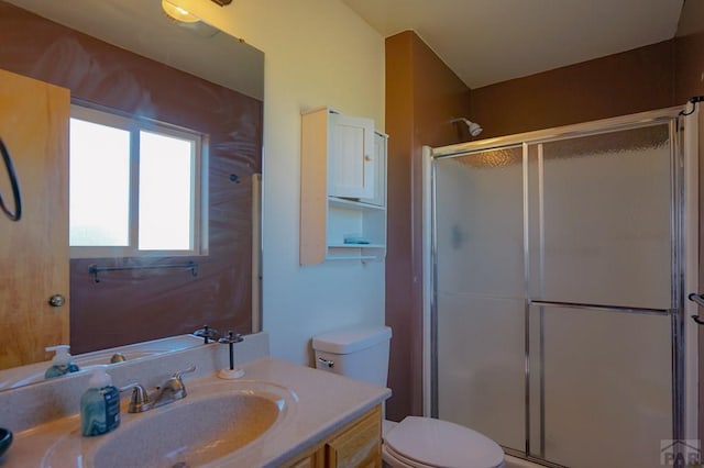 full bath with toilet, a shower stall, and vanity