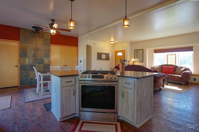 kitchen featuring gas stove, open floor plan, decorative light fixtures, and a kitchen island