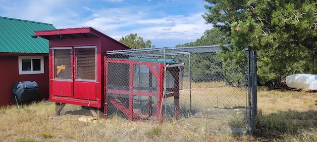 view of gate with exterior structure and an outbuilding