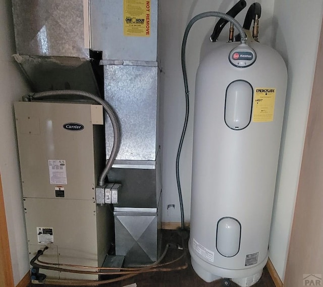 utility room featuring heating unit and water heater