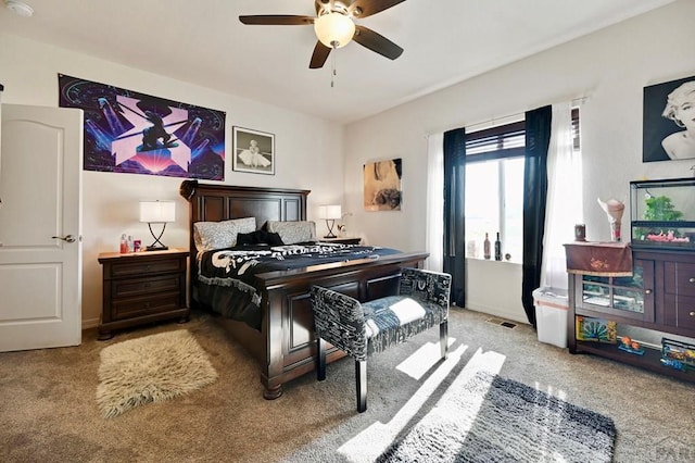 bedroom with light colored carpet, visible vents, and a ceiling fan