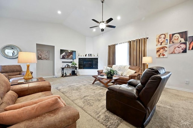 living room with high vaulted ceiling, a stone fireplace, a ceiling fan, baseboards, and carpet