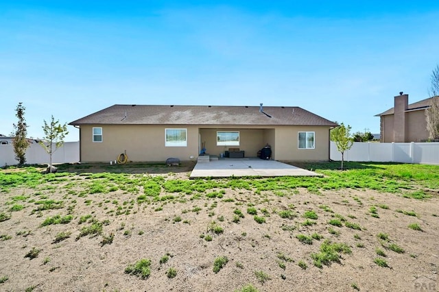 rear view of property with a patio area, a fenced backyard, and stucco siding