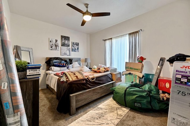 bedroom featuring ceiling fan and dark colored carpet