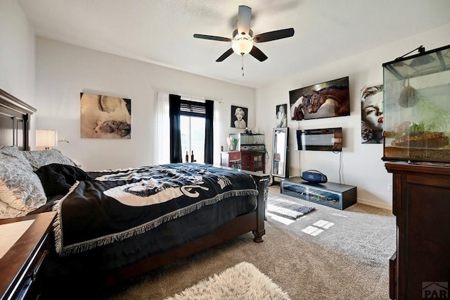 bedroom featuring ceiling fan, baseboards, and light colored carpet