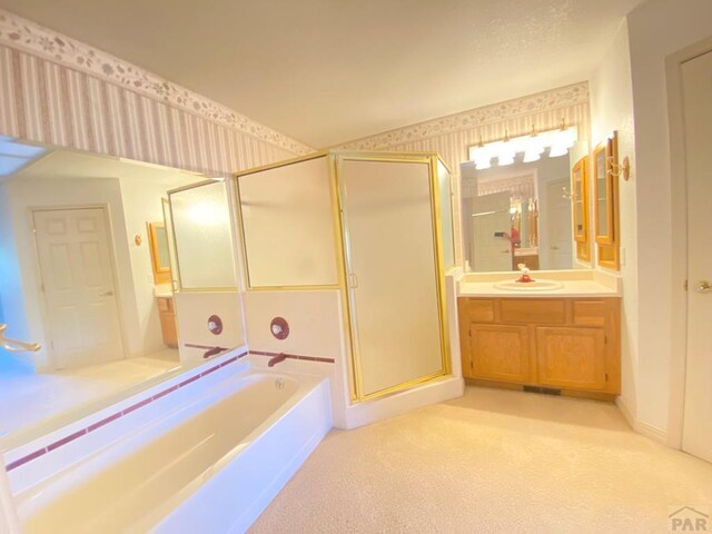 full bathroom with a shower stall, a garden tub, vanity, and wallpapered walls