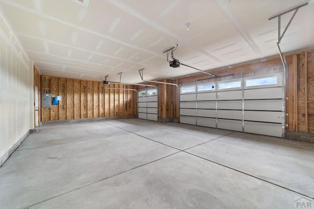 garage featuring electric panel and a garage door opener