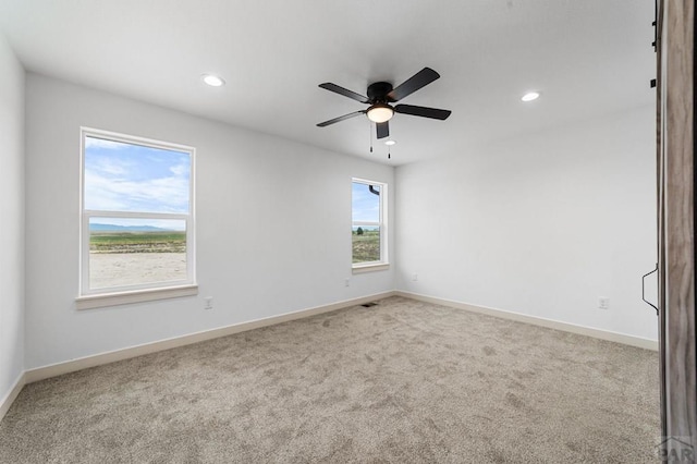 spare room with carpet, a ceiling fan, baseboards, and recessed lighting