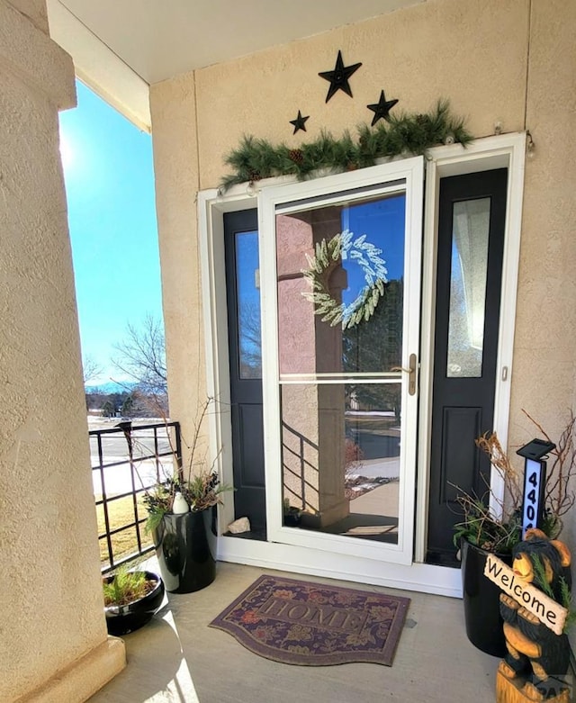 entrance to property with stucco siding