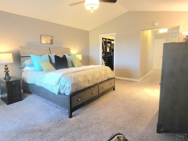 bedroom featuring visible vents, baseboards, a spacious closet, vaulted ceiling, and carpet flooring