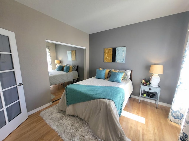 bedroom with wood finished floors and baseboards