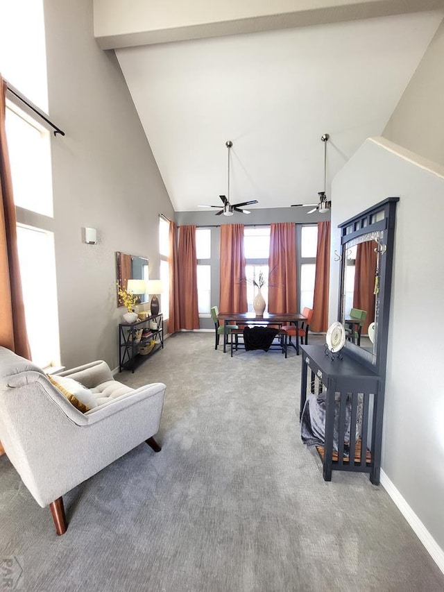 carpeted living room featuring high vaulted ceiling, a ceiling fan, and baseboards