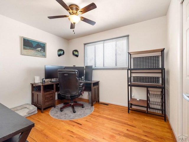 office featuring light wood-type flooring, ceiling fan, and baseboards