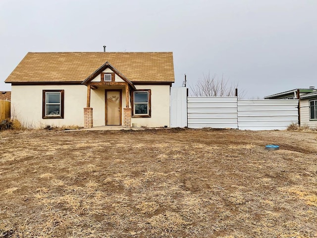 view of front of home featuring fence and stucco siding