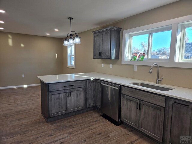 kitchen with dishwasher, dark wood-style floors, a peninsula, a sink, and recessed lighting