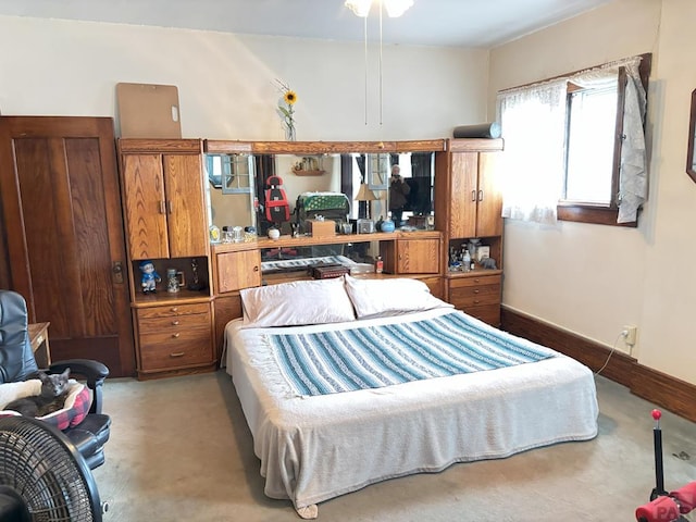 carpeted bedroom featuring baseboards