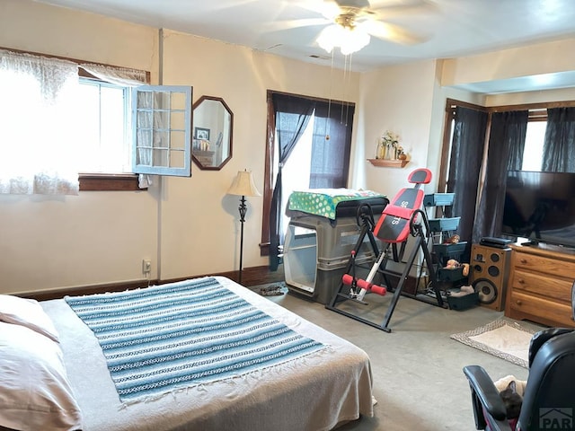 bedroom featuring ceiling fan and carpet