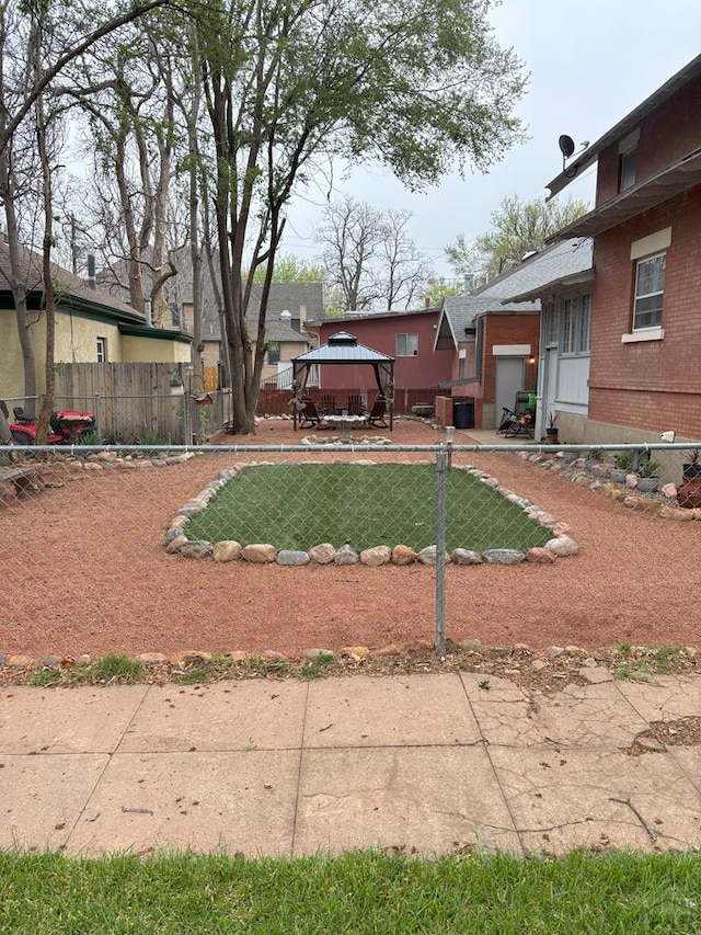 view of yard featuring a gazebo and fence private yard
