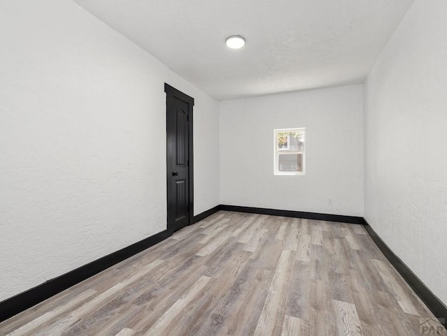 2803 Baltimore Ave, Pueblo, CO 81008 - empty room featuring light wood finished floors and a textured wall
