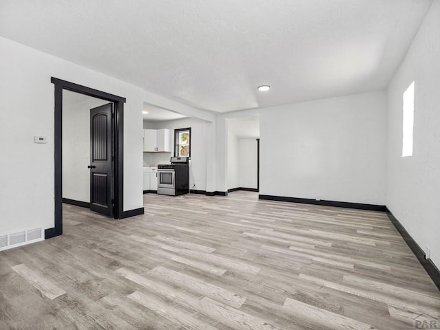 2803 Baltimore Ave, Pueblo, CO 81008 - unfurnished living room with light wood-style flooring and recessed lighting