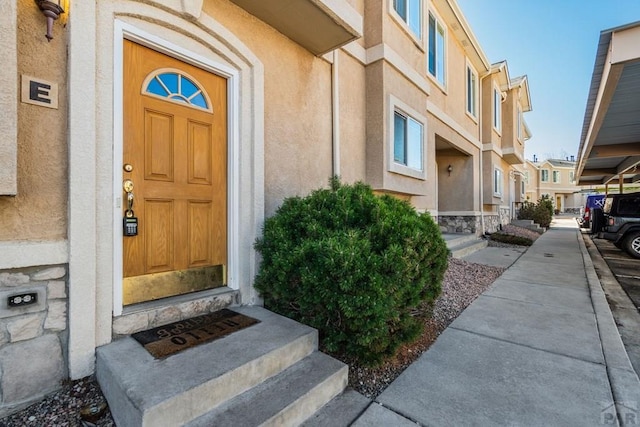 1447 Madison Ridge Hts Unit E, Colorado Springs, CO 80904 - entrance to property featuring stucco siding and stone siding
