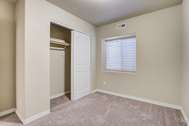1447 Madison Ridge Hts Unit E, Colorado Springs, CO 80904 - unfurnished bedroom with carpet, baseboards, and a closet