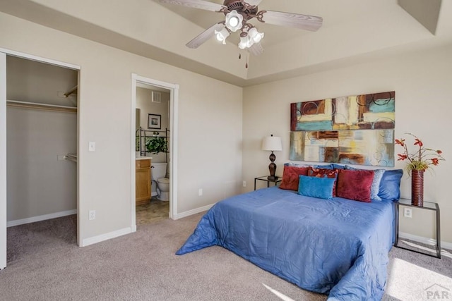 1447 Madison Ridge Hts Unit E, Colorado Springs, CO 80904 - carpeted bedroom featuring baseboards, a closet, a tray ceiling, ensuite bathroom, and a walk in closet