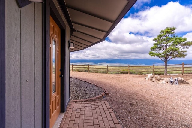 view of yard featuring fence and a view of rural / pastoral area