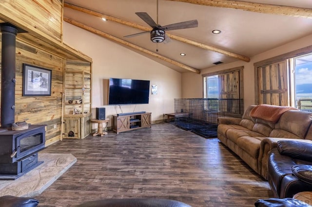 living area featuring a wood stove, plenty of natural light, recessed lighting, wood finished floors, and wood walls