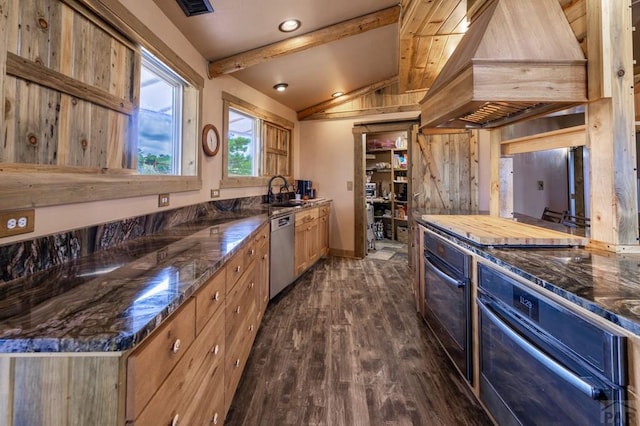 kitchen featuring stainless steel appliances, dark wood-style floors, dark stone countertops, baseboards, and recessed lighting