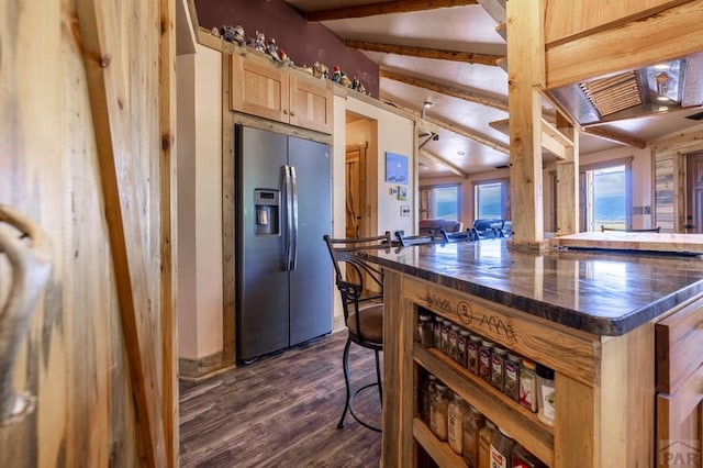 kitchen featuring stainless steel fridge with ice dispenser, dark wood finished floors, light brown cabinets, beam ceiling, and wooden counters