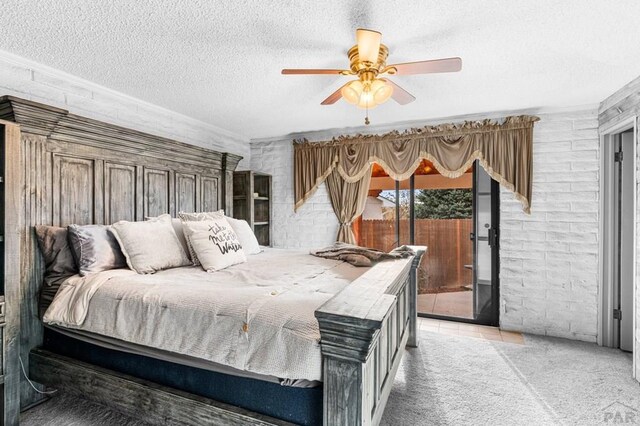 bedroom featuring access to exterior, carpet flooring, ceiling fan, and a textured ceiling