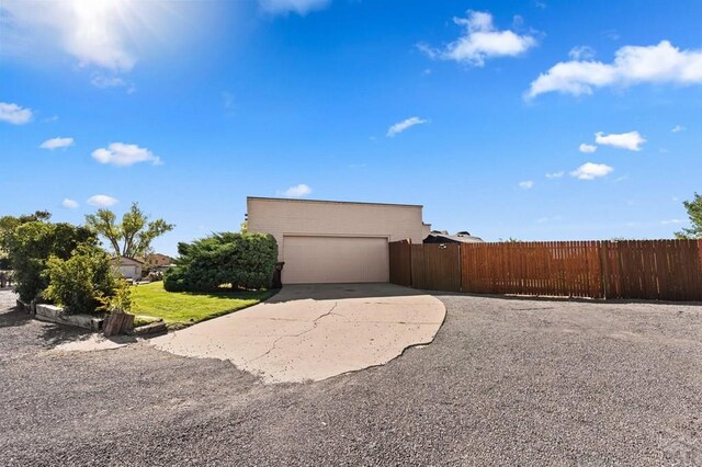 view of side of property with driveway and fence