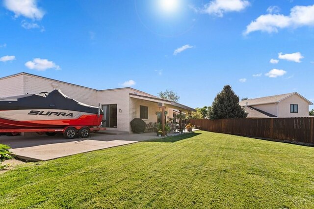 view of yard featuring a patio and fence