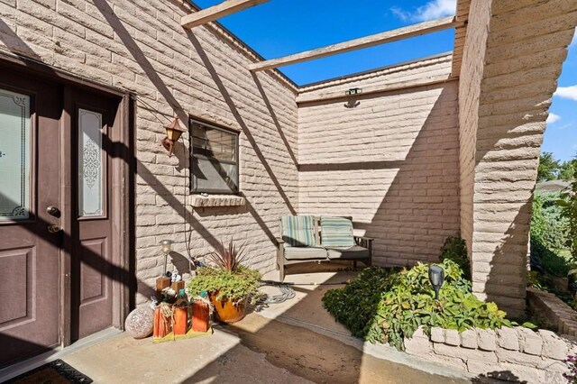 entrance to property featuring brick siding