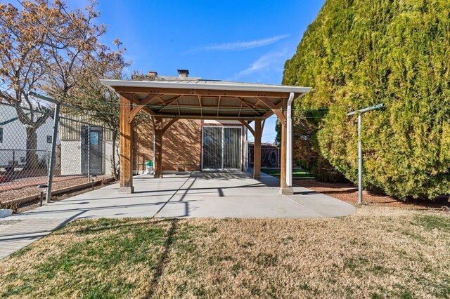 back of house featuring a yard, fence, and a gazebo