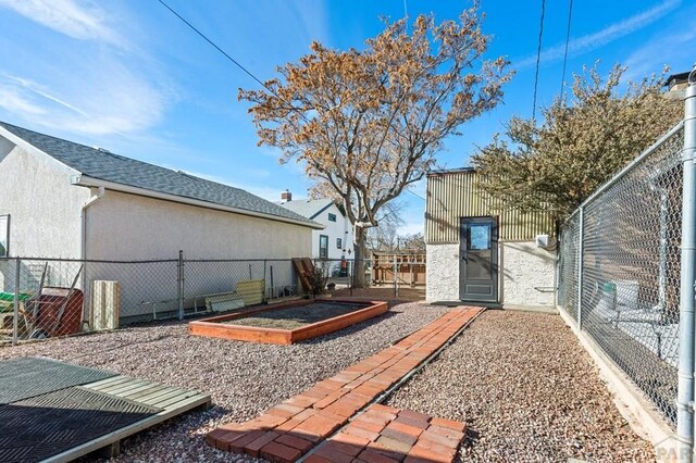 view of yard with a garden, a gate, and a fenced backyard