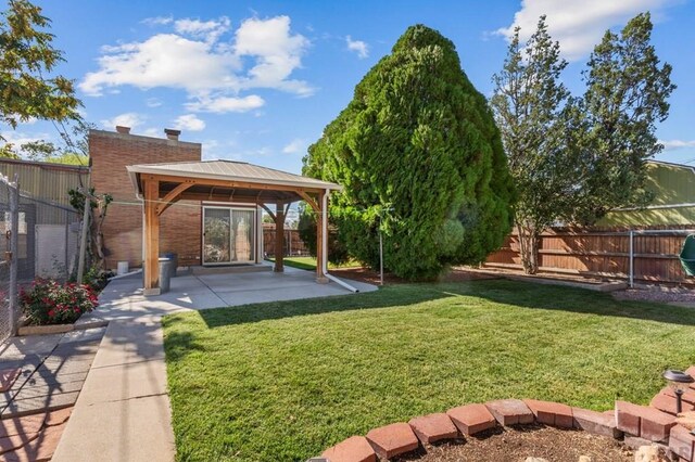 view of yard with a patio area, a fenced backyard, and a gazebo