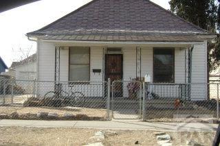 bungalow-style house featuring a fenced front yard, covered porch, roof with shingles, and a gate