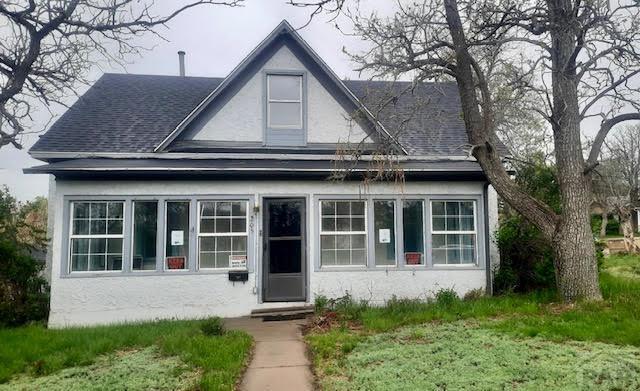 205 Tyler St, Walsenburg, CO 81089 - bungalow-style house with roof with shingles and stucco siding