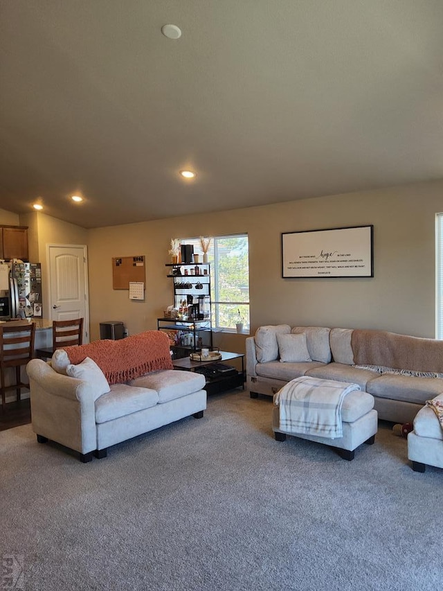 carpeted living area with lofted ceiling and recessed lighting