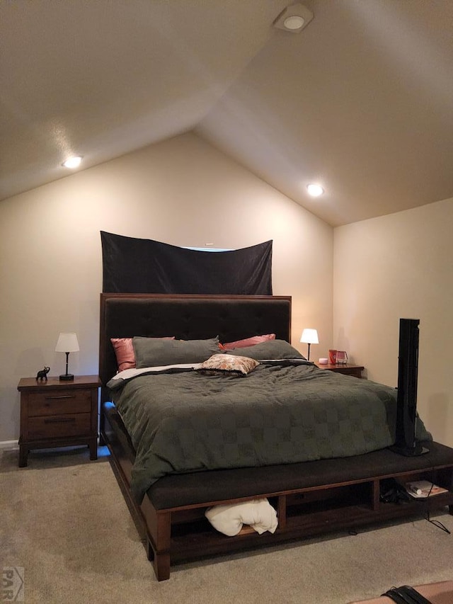 bedroom with carpet floors and vaulted ceiling