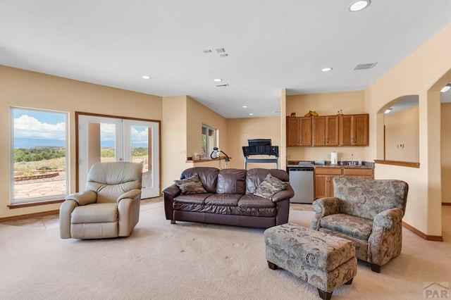 living room featuring baseboards, visible vents, light colored carpet, french doors, and recessed lighting